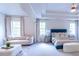 Spacious bedroom with large windows and sitting area at 2004 Fontainbleau Dr, Conyers, GA 30094