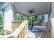 Covered deck with ceiling fan and wooden stairs at 2004 Fontainbleau Dr, Conyers, GA 30094