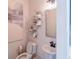 Small bathroom with pedestal sink, toilet and geometric shelving at 2004 Fontainbleau Dr, Conyers, GA 30094