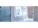 Spa-like bathroom with soaking tub, marble tile, and separate shower at 2004 Fontainbleau Dr, Conyers, GA 30094