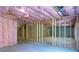 Unfinished basement with framed walls and pink insulation at 2004 Fontainbleau Dr, Conyers, GA 30094