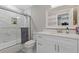 Clean bathroom with a shower/tub combo, white vanity, and marble tile at 3636 Evans Rd, Atlanta, GA 30340