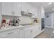 White kitchen cabinets, stainless steel range hood, quartz countertops, and built-in appliances at 3636 Evans Rd, Atlanta, GA 30340
