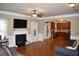 Open living room featuring hardwood floors, a fireplace, and kitchen views at 3853 Locksley Trl, Douglasville, GA 30135