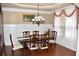 Formal dining room with chandelier and wainscoting at 3853 Locksley Trl, Douglasville, GA 30135