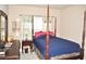 Elegant bedroom with a four-poster bed and window at 3853 Locksley Trl, Douglasville, GA 30135