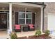 Inviting front porch with brick columns and seating at 3853 Locksley Trl, Douglasville, GA 30135