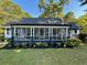 Cute white house with a screened porch and nicely landscaped front yard at 3970 Norman Rd, Stone Mountain, GA 30083