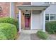 Front entry with a burgundy door and white columns at 801 Old Peachtree Nw Rd # 56, Lawrenceville, GA 30043