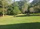 Large grassy backyard surrounded by lush greenery at 2681 Buford Hwy, Cumming, GA 30041