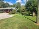 House with carport and a grassy front yard at 2681 Buford Hwy, Cumming, GA 30041