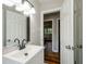 Clean bathroom with white vanity, dark-colored hardware, and hardwood floors at 123 Arnold Pl, Jonesboro, GA 30236