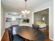 Dining area with black table and chairs, open to kitchen and living room at 123 Arnold Pl, Jonesboro, GA 30236