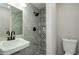 Modern bathroom with patterned tile shower and updated vanity at 123 Arnold Pl, Jonesboro, GA 30236