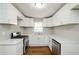Updated kitchen with white shaker cabinets, quartz countertops, and stainless steel appliances at 123 Arnold Pl, Jonesboro, GA 30236