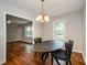 Dining room with a black oval table, and chandelier, open to the kitchen at 123 Arnold Pl, Jonesboro, GA 30236