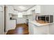 Modern kitchen with white cabinets, quartz countertops and stainless steel appliances at 123 Arnold Pl, Jonesboro, GA 30236
