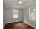 Spacious bedroom with hardwood floors, ceiling fan, and neutral wall color at 123 Arnold Pl, Jonesboro, GA 30236