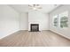 Living room with fireplace, wood-look floors, and a ceiling fan at 3024 Viewpark Cir, Conyers, GA 30013