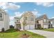 Two-story home with a two-car garage, landscaping, and a tree in the front yard at 3024 Viewpark Cir, Conyers, GA 30013