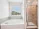 Bathroom with soaking tub, shower, and view from window at 3024 Viewpark Cir, Conyers, GA 30013