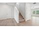 Elegant staircase with carpeted steps and light wood flooring at 3024 Viewpark Cir, Conyers, GA 30013