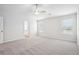 Spacious main bedroom with ceiling fan, grey carpet, and en-suite bathroom at 3024 Viewpark Cir, Conyers, GA 30013