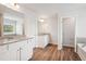 Bathroom boasts double sinks, granite countertops, and wood-look flooring at 3024 Viewpark Cir, Conyers, GA 30013