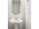 Small bathroom with pedestal sink and an oval mirror at 3024 Viewpark Cir, Conyers, GA 30013