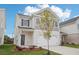 Two-story house with gray siding, white garage door and landscaping at 1014 Northfield Dr, Conyers, GA 30013