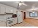 Kitchen with white cabinets and view into dining area at 2341 Cedar Dr, Lawrenceville, GA 30043