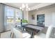 Dining area with chandelier, large windows, and view of the home office at 6200 Misty Hill Ln, Buford, GA 30518