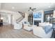 Living room with white couches, a fireplace, a staircase, and built-in shelving units at 6200 Misty Hill Ln, Buford, GA 30518