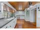 White kitchen with granite countertops and wood flooring at 150 E Main St, Rutledge, GA 30663