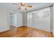 Hardwood floor bedroom with built-in shelving and ceiling fan at 150 E Main St, Rutledge, GA 30663
