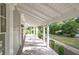 Long front porch with white columns and wooden flooring at 150 E Main St, Rutledge, GA 30663