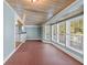 Sunroom with terracotta tile floor and wall of windows at 150 E Main St, Rutledge, GA 30663
