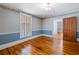 Hardwood floor bedroom with built-in shelving and door to bathroom at 150 E Main St, Rutledge, GA 30663