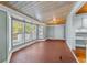 Sunroom features terracotta tile floor and wall of windows at 150 E Main St, Rutledge, GA 30663