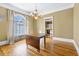 Bright dining room with hardwood floors, chandelier, and view into kitchen at 150 E Main St, Rutledge, GA 30663