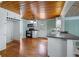 Kitchen features wood ceiling, white cabinets, and black appliances at 150 E Main St, Rutledge, GA 30663