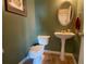 Clean powder room with pedestal sink and green walls at 6148 Indian Wood Se Cir, Mableton, GA 30126
