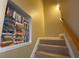 Carpeted staircase with a built-in VHS movie collection at 6148 Indian Wood Se Cir, Mableton, GA 30126