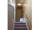 Upper level staircase with carpeted steps, neutral walls, and small table at 6148 Indian Wood Se Cir, Mableton, GA 30126
