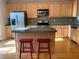 Kitchen with light wood cabinets, granite island, and stainless steel appliances at 6148 Indian Wood Se Cir, Mableton, GA 30126
