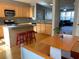 Open kitchen with island, hardwood floors, and view into living room at 6148 Indian Wood Se Cir, Mableton, GA 30126