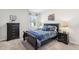 Bedroom with black bed frame and dresser at 1012 Northfield Dr, Conyers, GA 30013