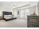 Spacious main bedroom with a large bed and ceiling fan at 1012 Northfield Dr, Conyers, GA 30013