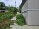 Side view of house with overgrown walkway and deck at 2010 Driftwood Cir, Cumming, GA 30041