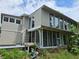 Home's exterior with a large screened porch and stonework at 2010 Driftwood Cir, Cumming, GA 30041